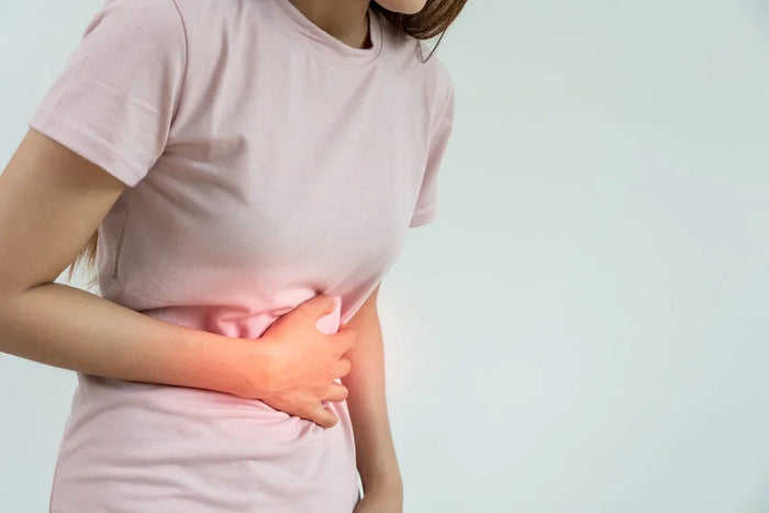 woman clutching sore stomach