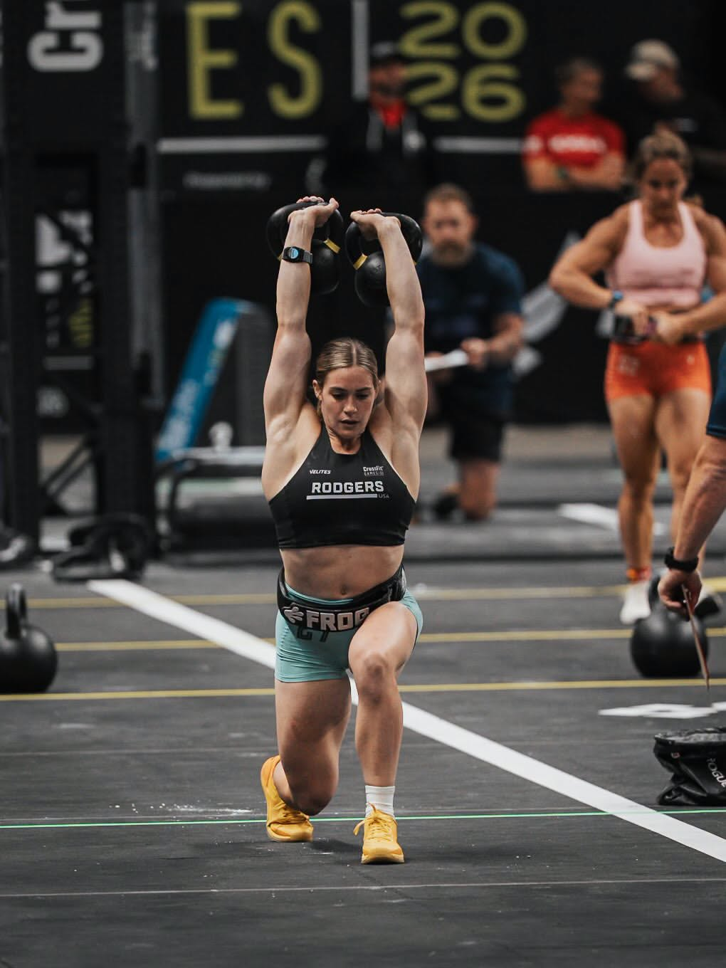 Athlete sitting on the box after a WOD, treating a sore knee with the Novaa Knee Ultra